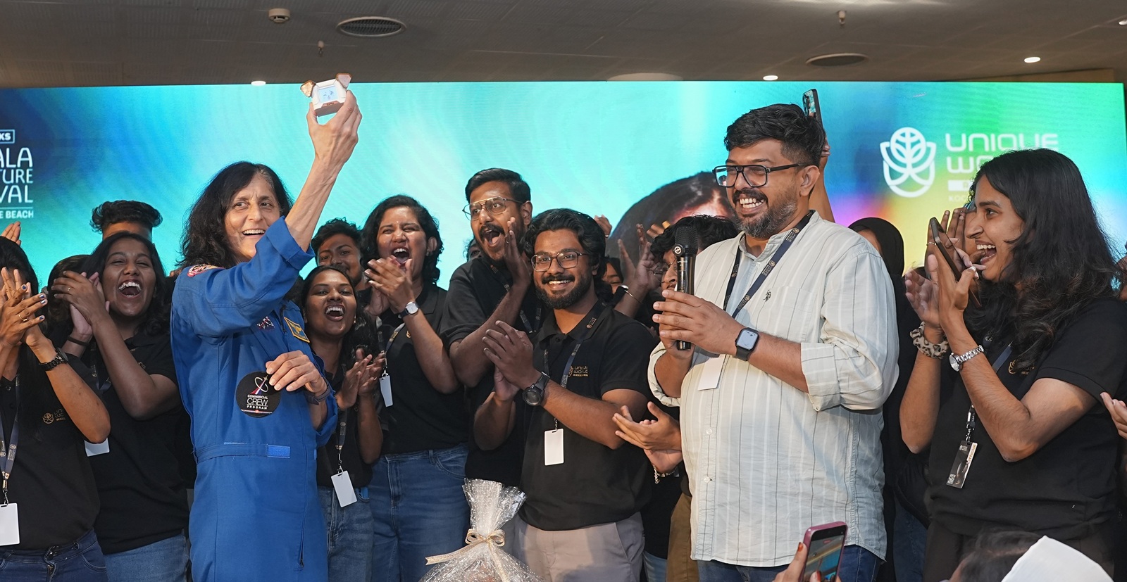 Unique World Robotics presents a ‘robot puppy’ to Sunita Williams